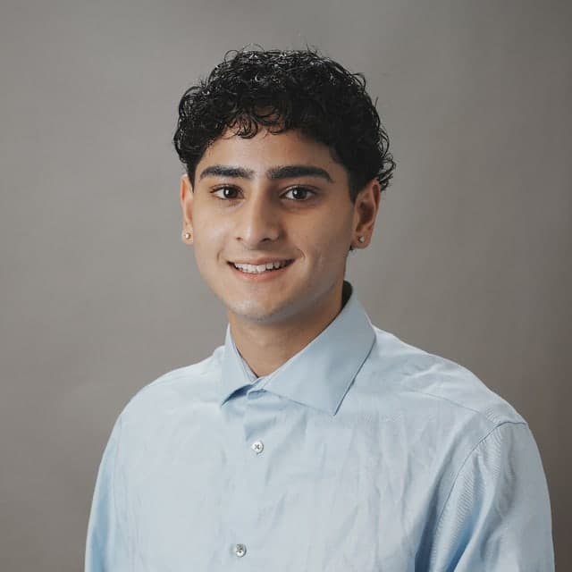 Rohan Kulkarni, smiling in a light blue shirt